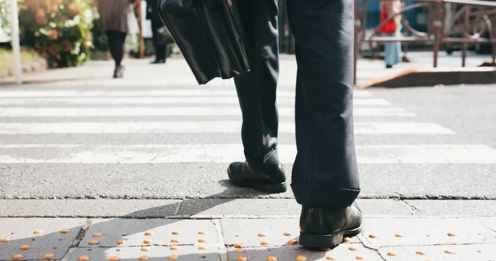Business man using the crosswalk