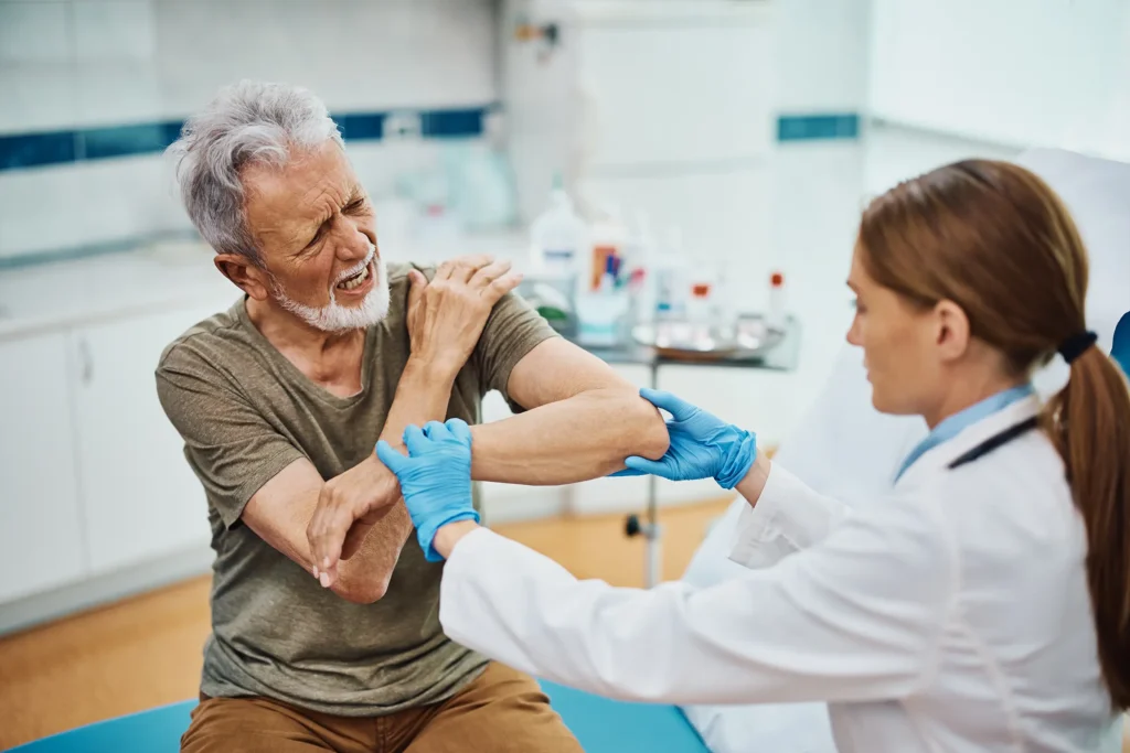 Orthopaedist examine senior patient