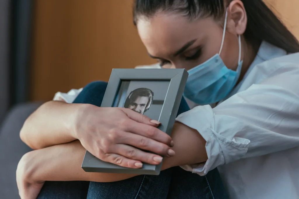Young grieving woman holding picture