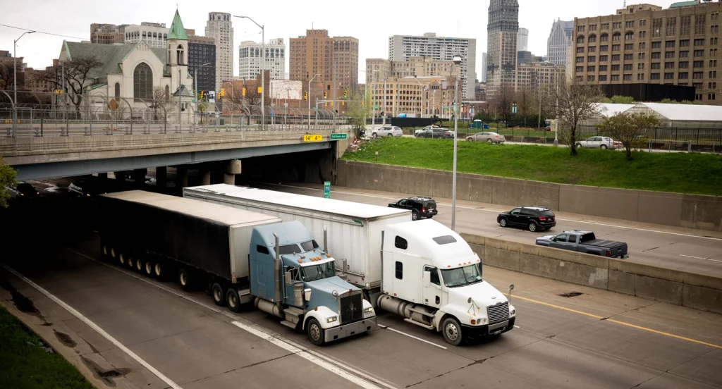 Transport trucks in city on highway