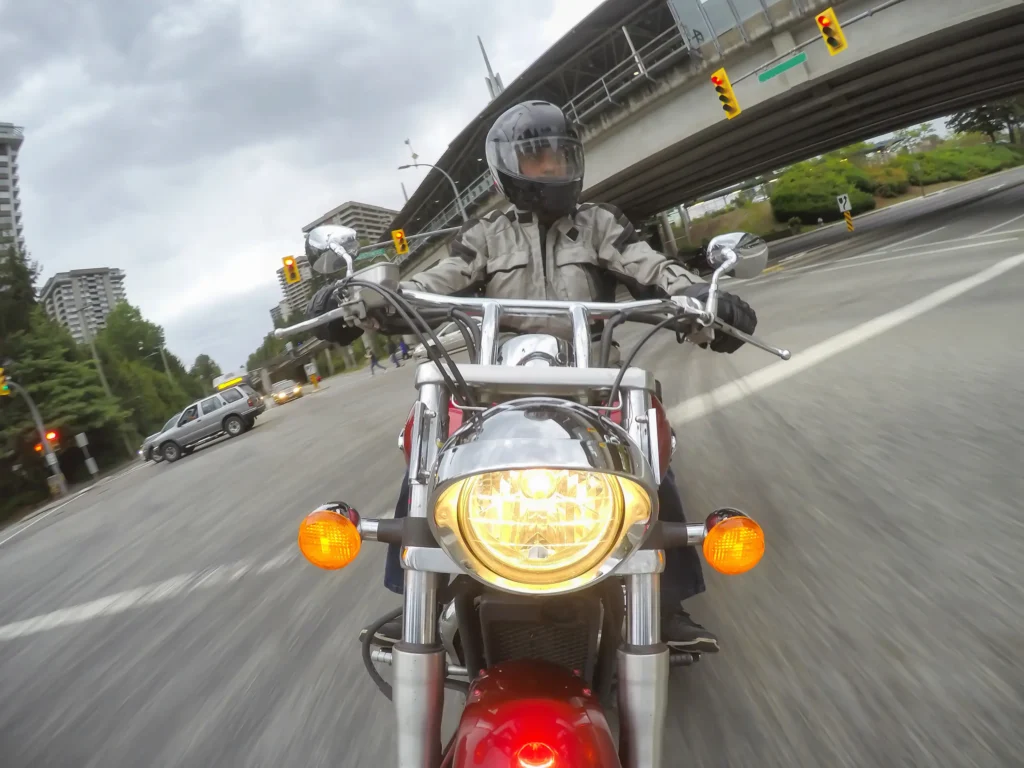 man riding motorcycle on city street