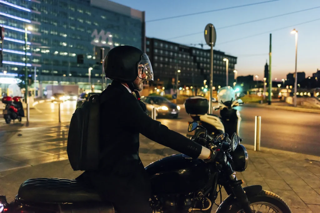 mature man riding motocycle at night