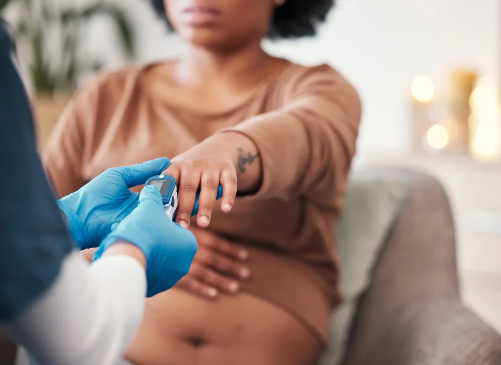 Dr. checking pulse of pregnant woman