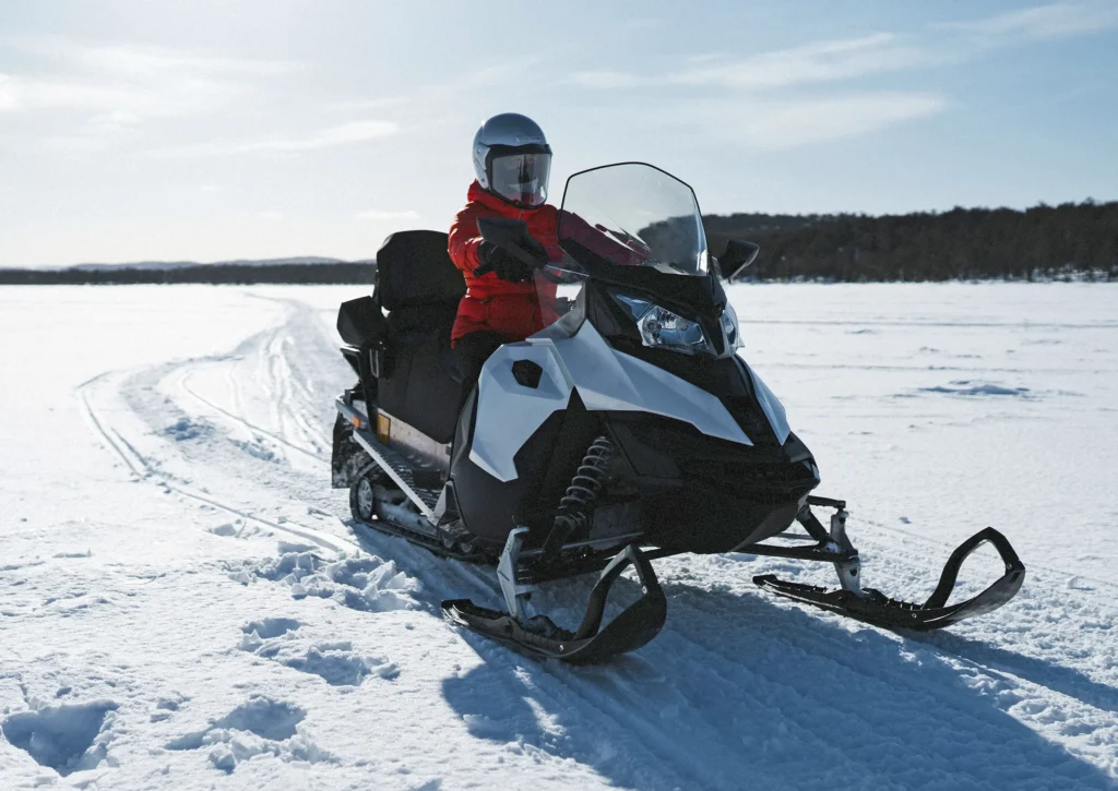 Woman driving snowmobile on Lake
