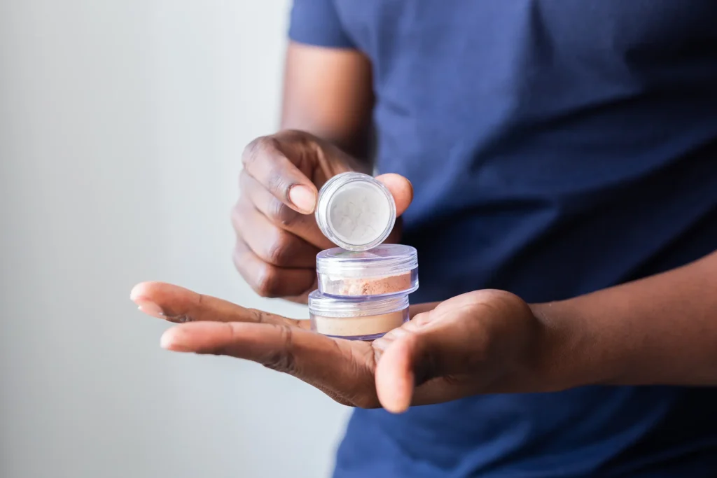 man holds mineral facial powder