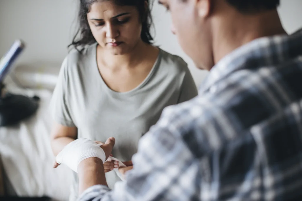 applying a gauze bandage to hand