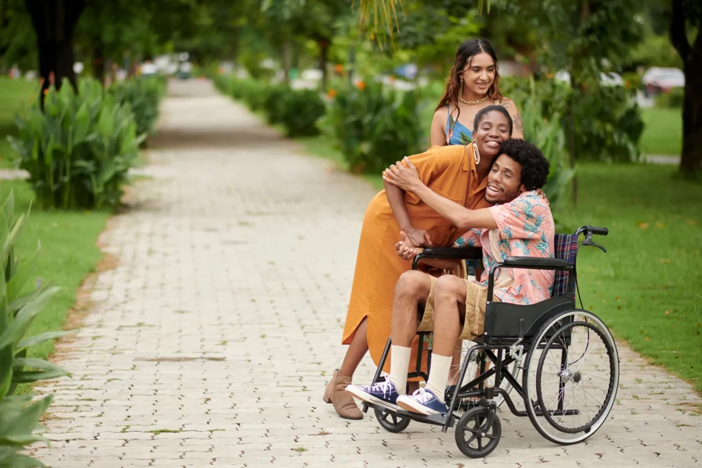 women hugging friend in wheelchair