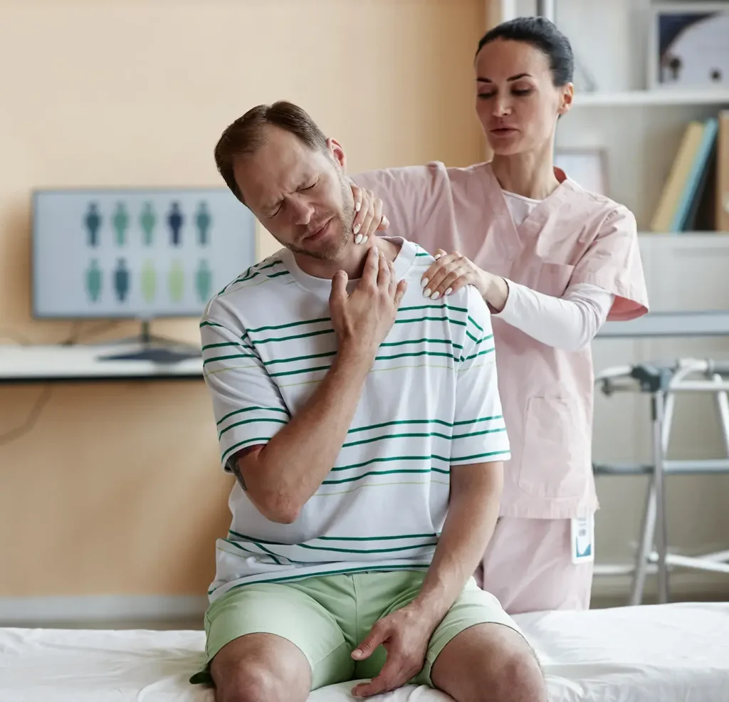 Female doctor examining pain neck of patient during his visit to hospital